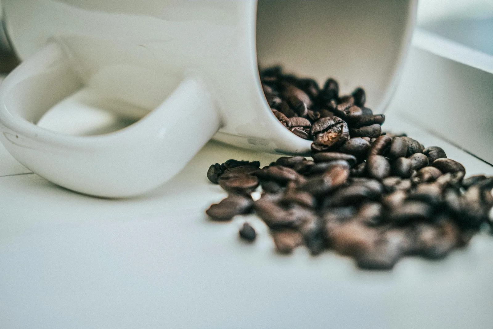 Cup of coffee beside a clock illustrating caffeine timing before bedtime