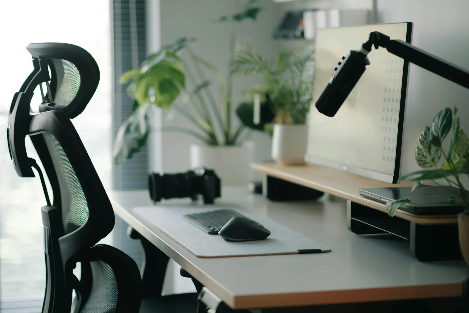 Ergonomic chair, monitor arm, keyboard, and mouse in a home office