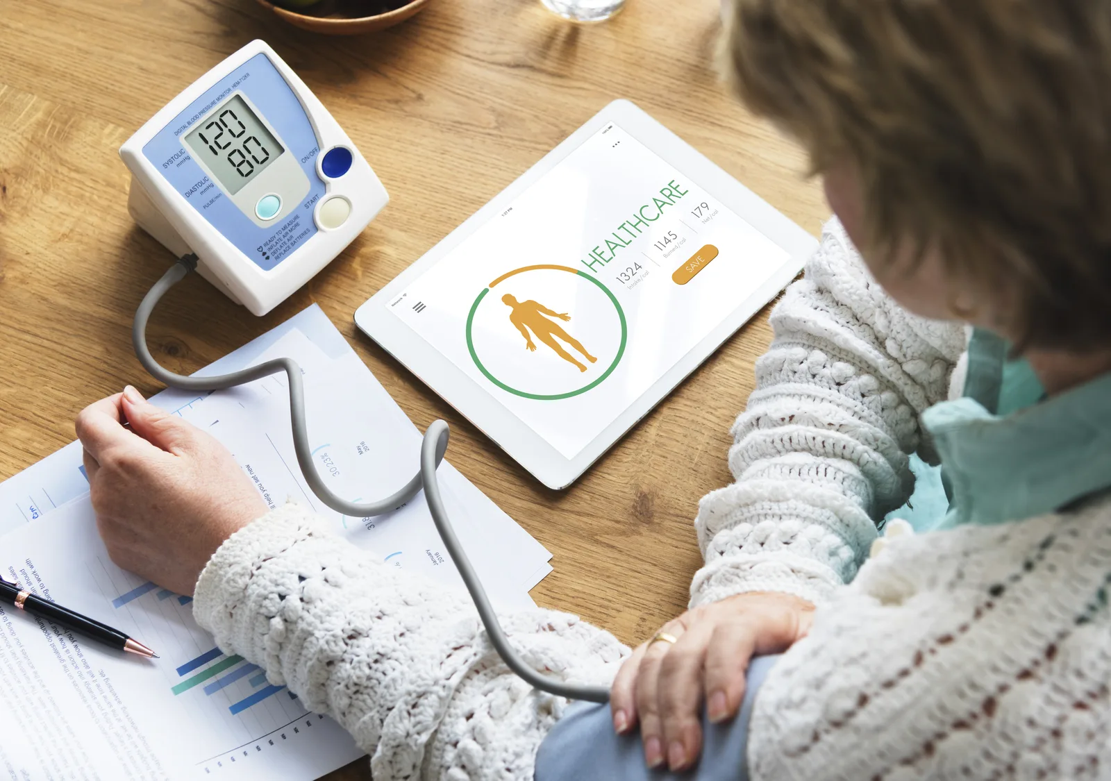 Home blood pressure monitor with upper-arm cuff, display, and storage case