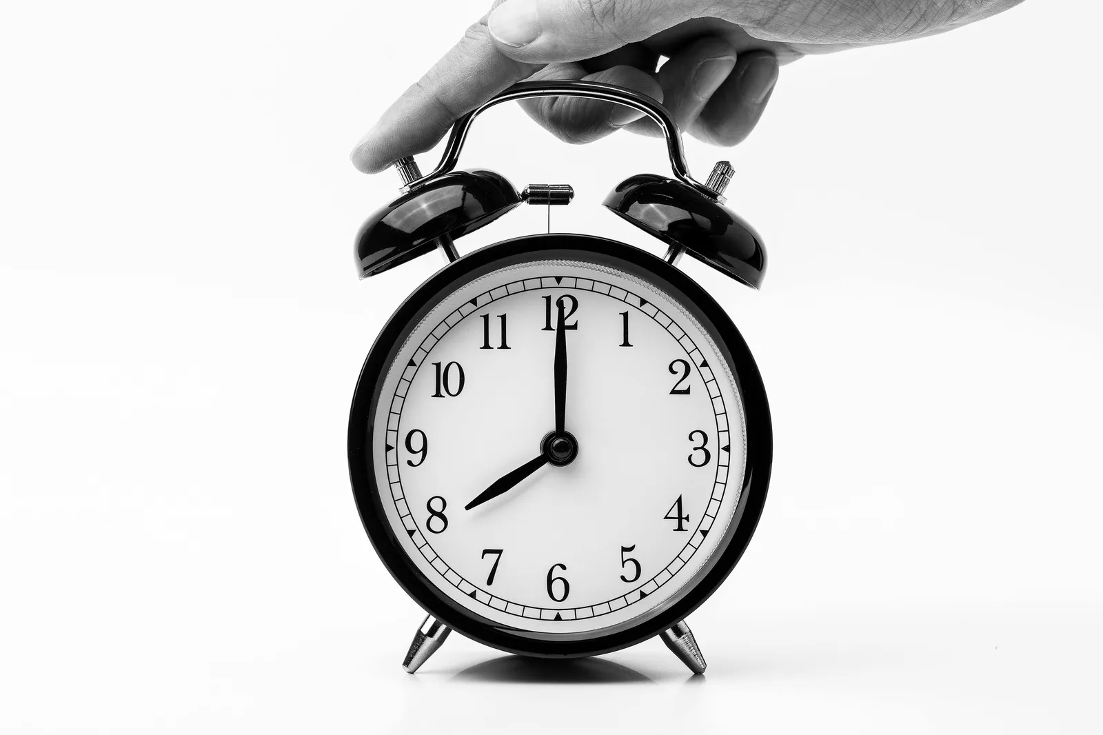 Bedside clock and morning light used to support a consistent sleep schedule